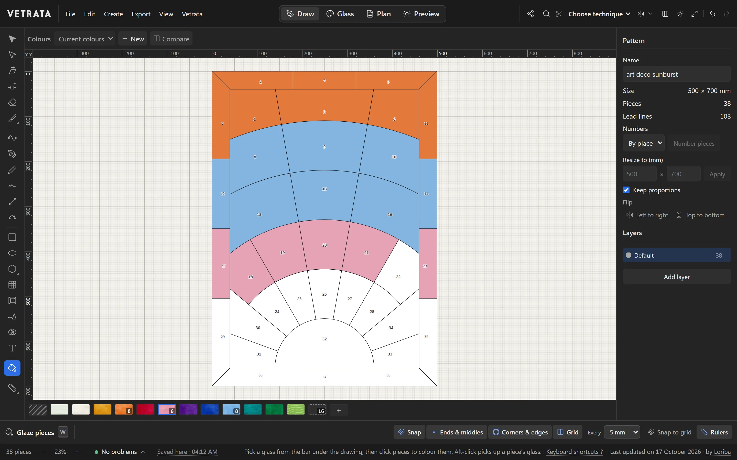 The Art Deco sunburst being glazed with the Glaze pieces tool: the top rows in orange, blue and pink, the rays below still white, the glass bar under the drawing.